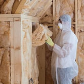 Tech installing insulation in home